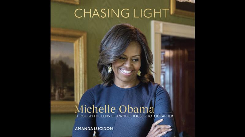 This cover image released by Ten Speed Press shows, \Chasing Light: Michelle Obama Through the Lens of a White House Photographer,\ by Amanda Lucidon. Ten Speed Press told The Associated Press on Tuesday, July 11, 2017, that the collection of White House pictures of Michelle Obama is coming out Oct. 17. (Amanda Lucidon/Ten Speed Press via AP)