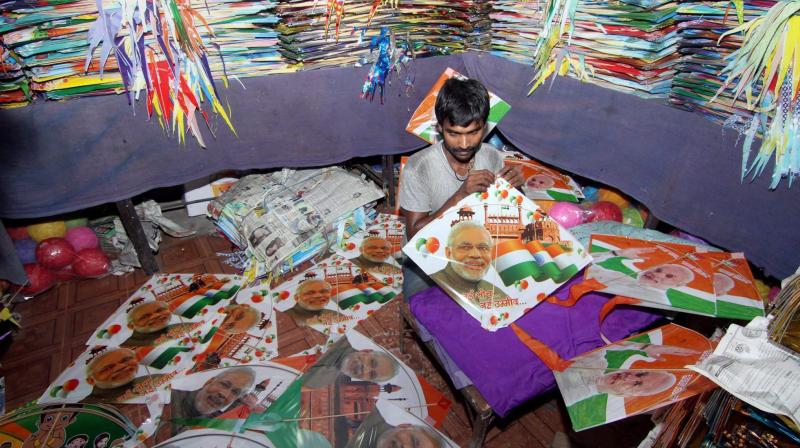 A worker making kites with picture of Modi printed on them (Photo: AP)