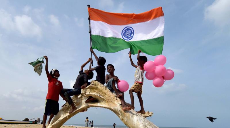 Youngsters wave the national flag (Photo: PTI)