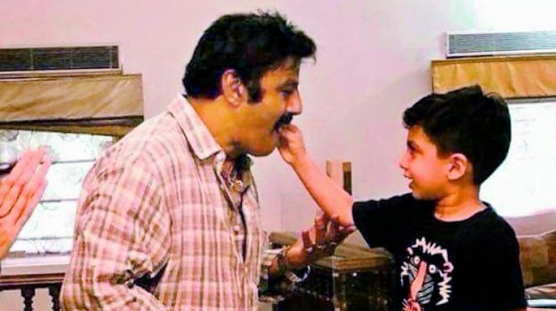 A picture of the actors grandson Devansh feeding him a piece of cake has gone viral on social media.