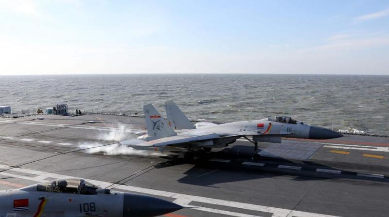 A Chinese J-15 fighter jet lands on the deck of the Liaoning aircraft carrier during military drills in the Bohai Sea, off Chinas northeast coast. (Photo: AFP)