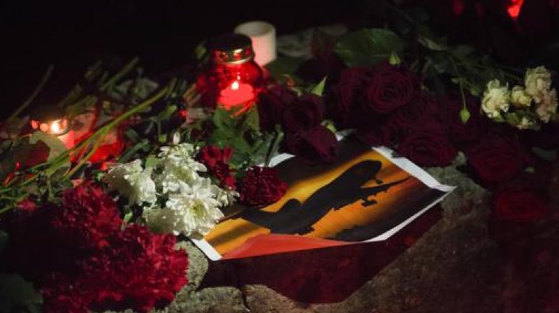 Flowers and candles are placed in memory of victims of the crashed plane in the center of Sochi, Russia. (Photo: AP)