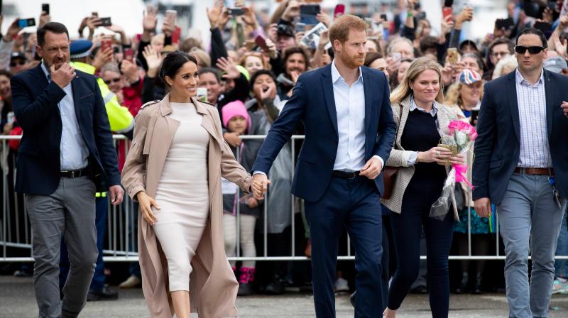 Britains Prince Harry (C) and his wife Meghan, Duchess of Sussex (2nd L) meet well-wishers during a public walk along the Viaduct Harbour in Auckland on October 30, 2018. (Photo: AFP)