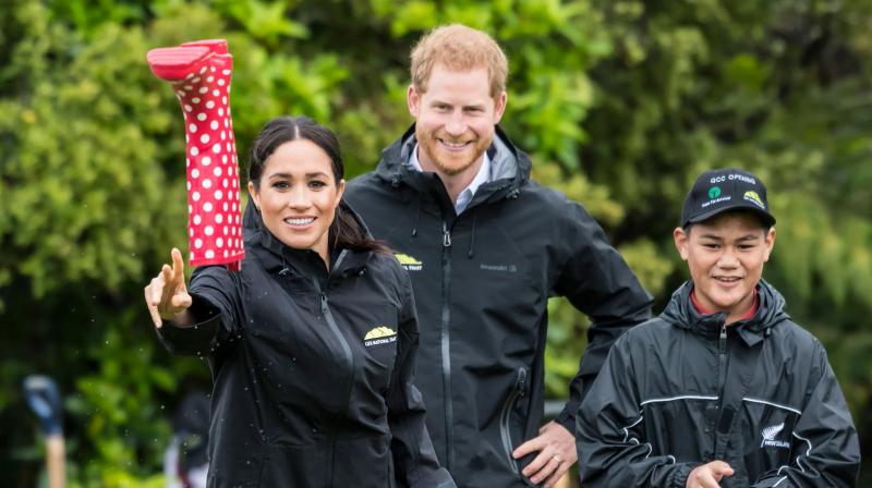Britains Meghan, Duchess of Sussex participates in a gumboot throwing competition with Prince Harry after unveiling a plaque dedicating 20 hectares of native bush to the Queens Commonwealth Canopy project at The North Shore Riding Club in Auckland on October 30, 2018.(Photo: AFP)