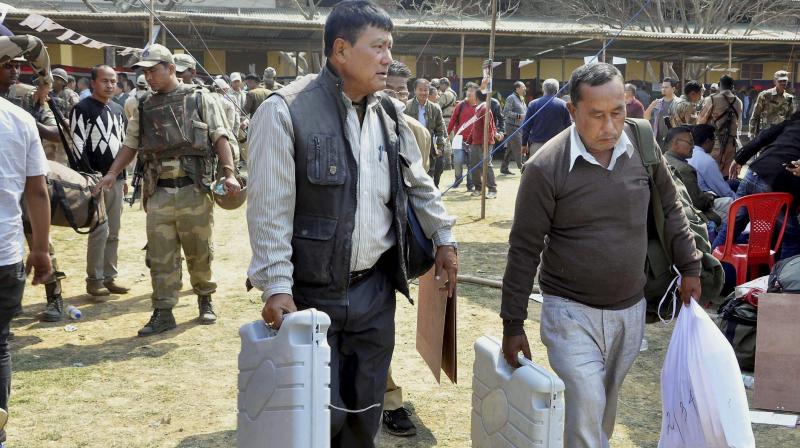 Officials leave for election duty on the eve of voting for the Assembly polls at Porompat, Imphal East. (Photo: PTI)