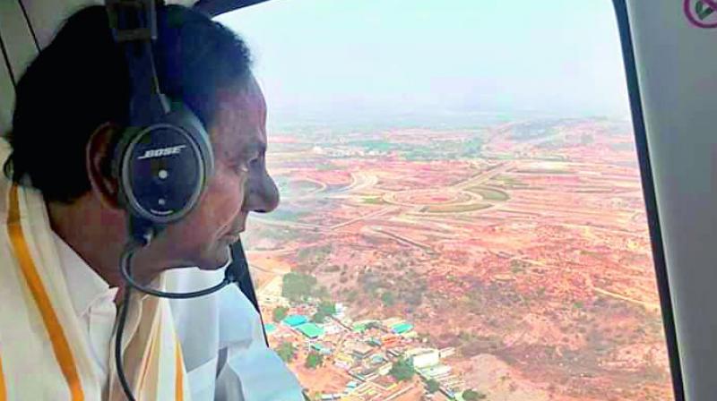 Chief Minister K. Chandrasekhar Rao takes an aerial survey of the renovation works of the Lakshmi Narasimha Swamy temple at Yadadri on Sunday.