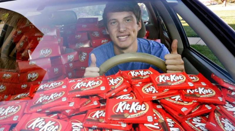 Hunter Jobbins, freshman at Kansas State University, poses in his car filled with nearly 6,500 Kit Kat bars in Manhattan, Kansas. (Photo: AP)