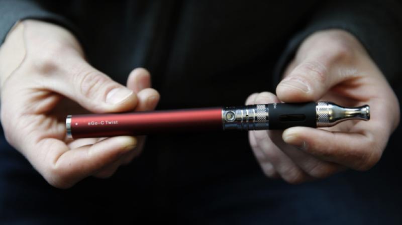 E-cigarette vaping is reported by 37 per cent of US 10th-grade adolescents and is associated with subsequent initiation of combustible cigarette smoking. (Photo: AP)