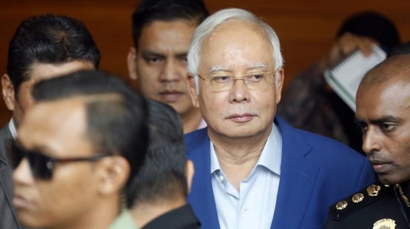 Police say he will face 21 money-laundering charges related to the mysterious transfer of huge sums into his personal bank account, a key episode in the long-running scandal. He may also face additional charges under anti-corruption laws. (Photo: AP)