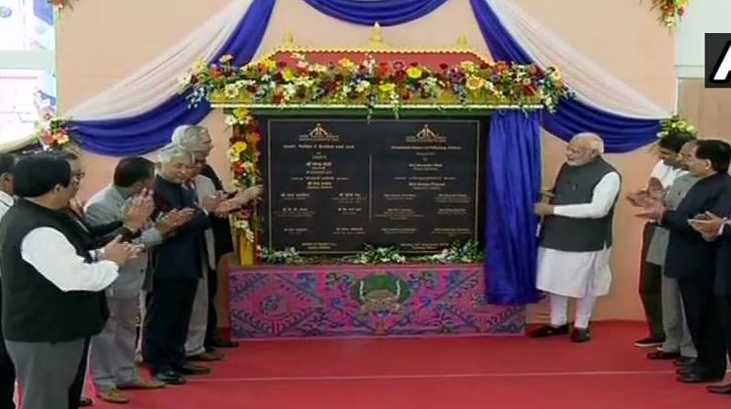 PM Modi was accompanied by Chief Minister Pawan Chamling and Union Aviation Minister Suresh Prabhu as he unveiled the plaque, formally inaugurating the aero facility. (Photo: Twitter | @ANI)