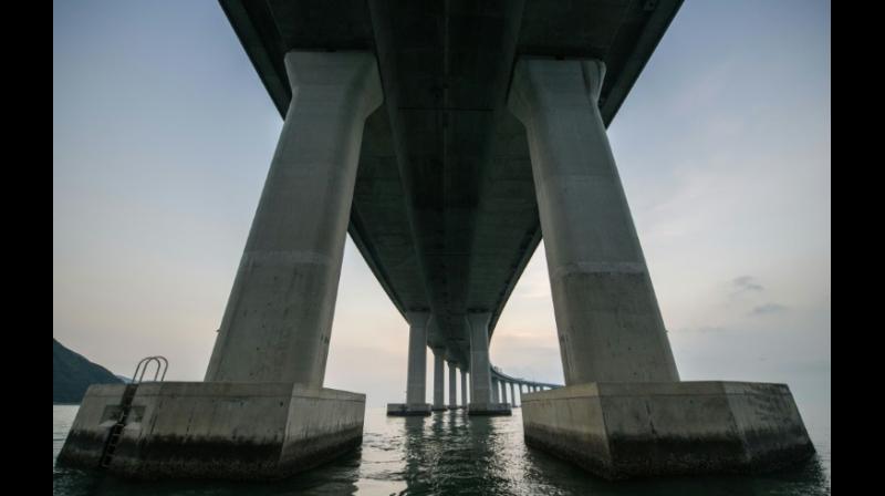 The 55-kilometer crossing, which includes a snaking road bridge and underwater tunnel, links Hong Kongs Lantau island to Zhuhai and the gambling enclave of Macau, across the waters of the Pearl River Estuary. (Photo: AFP)