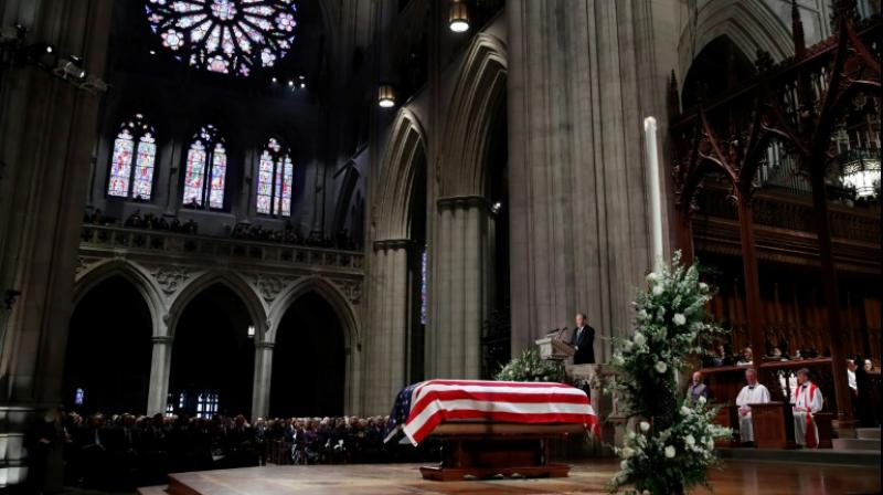 George W Bush delivers a eulogy beside the flag-draped casket of his father George HW Bush, during his state funeral at Washington National Cathedral. (Photo: AFP)