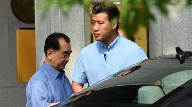 Kim Chang Son (left), North Korean leader Kim Jong Uns de facto chief of staff, going into a car as he leaves a hotel in Singapore, on May 29, 2018. (Photo: AFP)