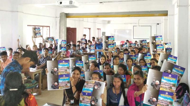 Students of SCV Higher Secondary School with the notebooks they made.