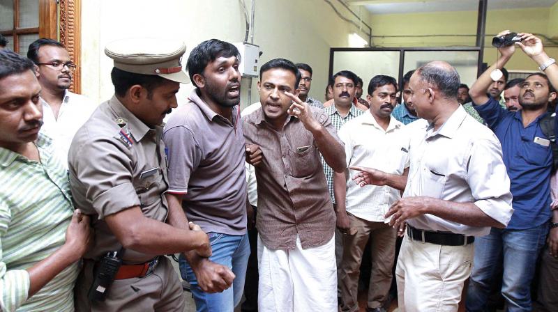 Police removing the activists who threatened to commit suicide on the Kanjirathinal land issue from Wayanad Collectorate on Friday.