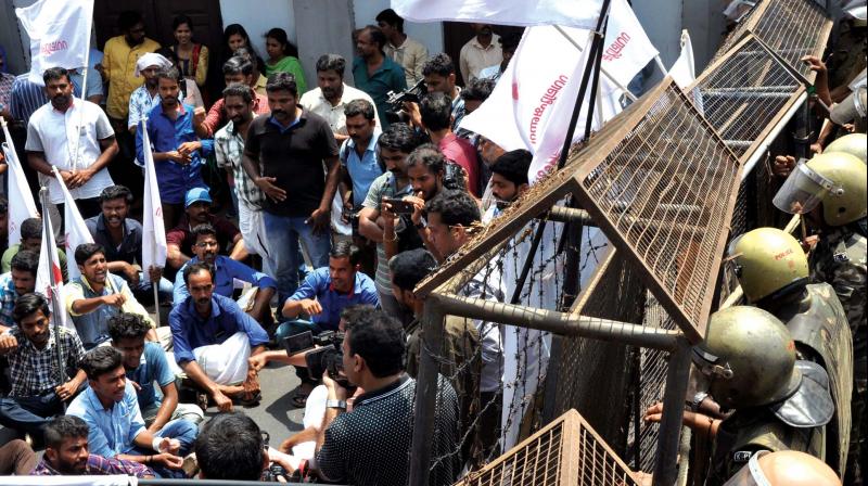 RMP workers sit in front of the ADGP office at Nadakkavu, Kozhikode when police blocked their protest march on Friday.