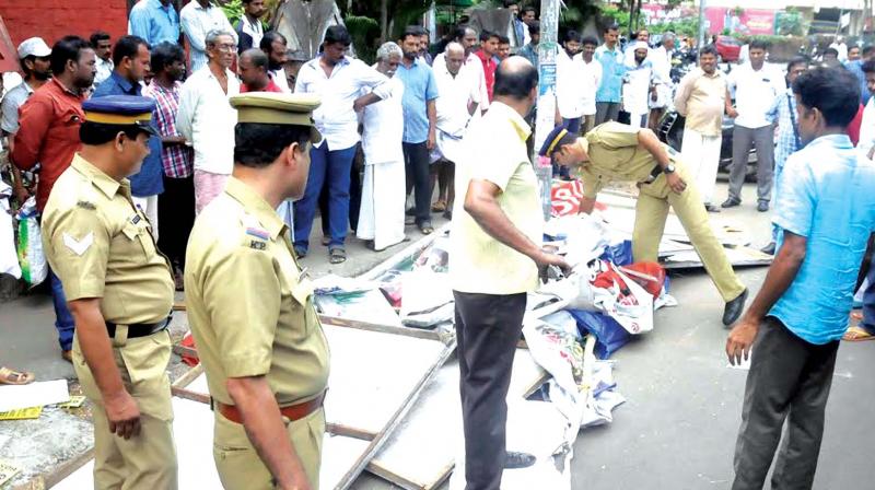 Police officials removing hoardings and flex boards on Friday.  (Photo: DC)