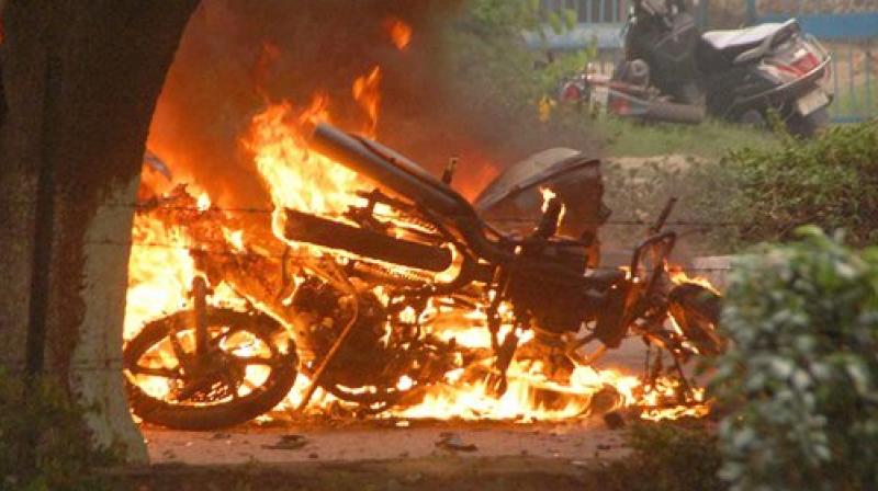 A bike burn in violence following Dera Sacha Sauda chief Gurmeet Ram Rahims conviction in Panchkula on Friday. (Photo: PTI)