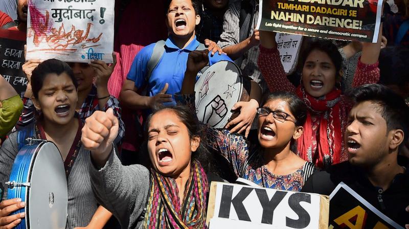 All India Students Association (AISA) and Jawaharlal Nehru University students shout slogans as they hold a protest demanding the arrest of Akhil Bharatiya Vidyarthi Parishad (ABVP) members at the police headquarters in New Delhi. (Photo: PTI)