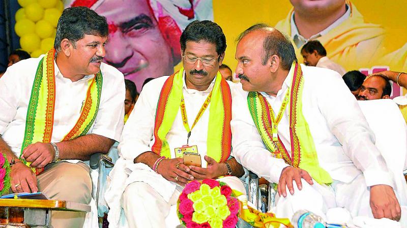 Minister for civil supplies P .Pulla Rao shares a word with Ponnuru MLA D. Narendra Kumar during the Telugu Desam Mini Mahanadu at Guntur on Tuesday. Telugu Desam Guntur district president and Vinukonda MLA G.V. Anjaneyulu is also seen. (Photo: DC)