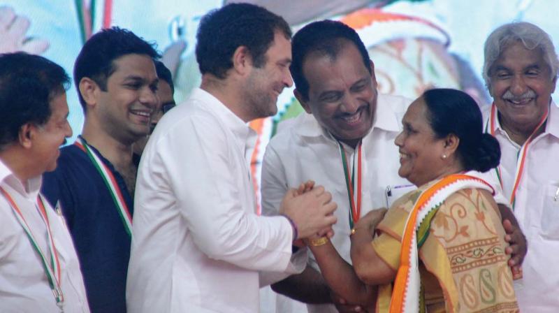 Rosy Stanley, president of the host booth Marine Drive, being honored by Congress president Rahul Gandhi at a convention of partys booth presidents and women vice-presidents in Kochi on Tuesday. Opposition leader Ramesh Chennithala, Hibi Eden, MLA, UDF convener Benny Behanan, and AICC general secretary Oommen Chandy look on . (Photo: SUNOJ NINAN MATHEW)