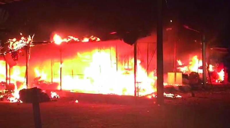 Fire rages at the Maddannapet vegetable market on Sunday.