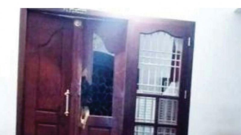 The broken window panes at the house of Sreedharan in Perambra