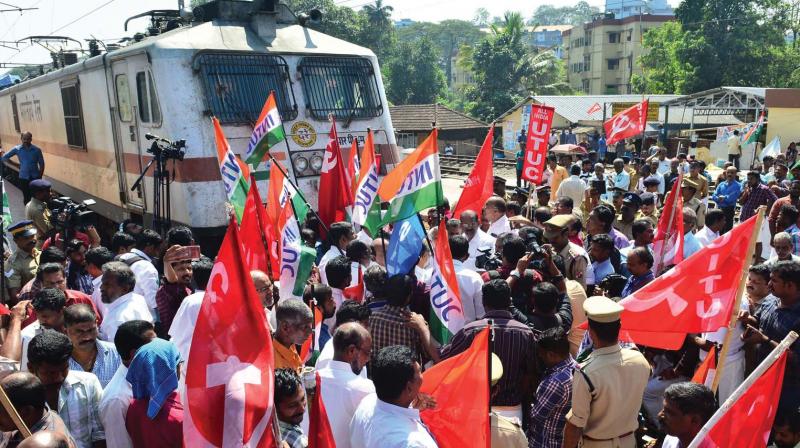 Various trade union members block train as part of the national strike at Kottayam railway station, Wednesday.