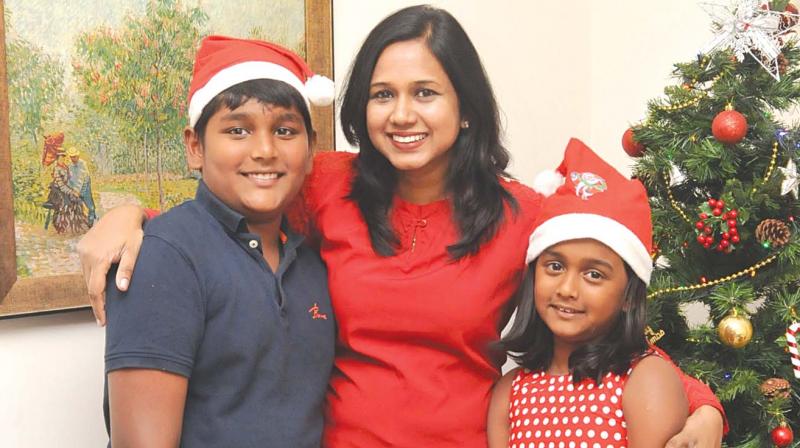 Shekhinah and her children, Sara and Jason, have a tradition of carol singing together in this photograph that was specially shot