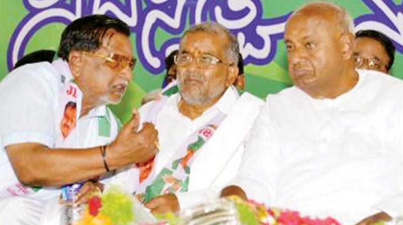Chamundeshwari JD(S) MLA G.T. Deve Gowda (centre) with party supremo H.D. Deve Gowda ina  file photo.