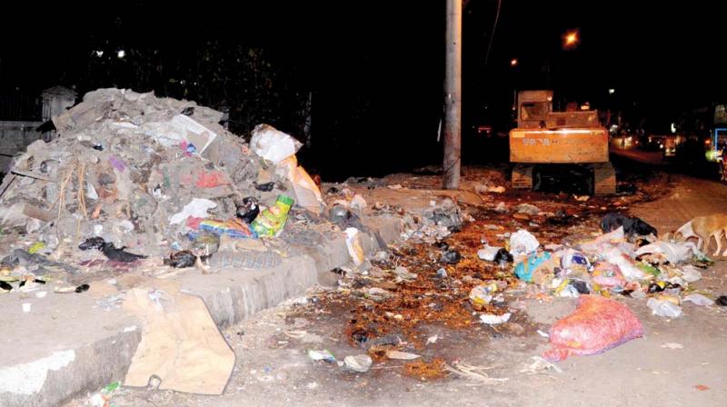 A large dump of garbage on 80 Feet Road at Ejipura  near Koramangala