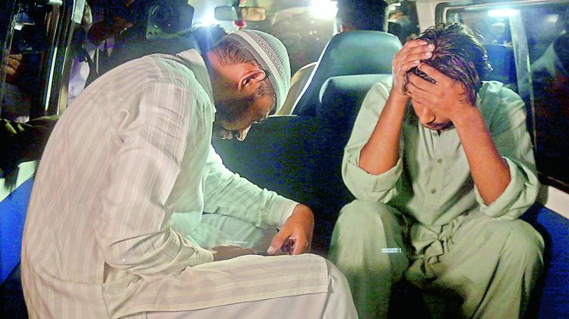 Relatives of Imran Ali convicted of killing eight children avoid media in a van while arrivIng to receive his body at a prison in Lahore on Wednesday    (Photo:AP)