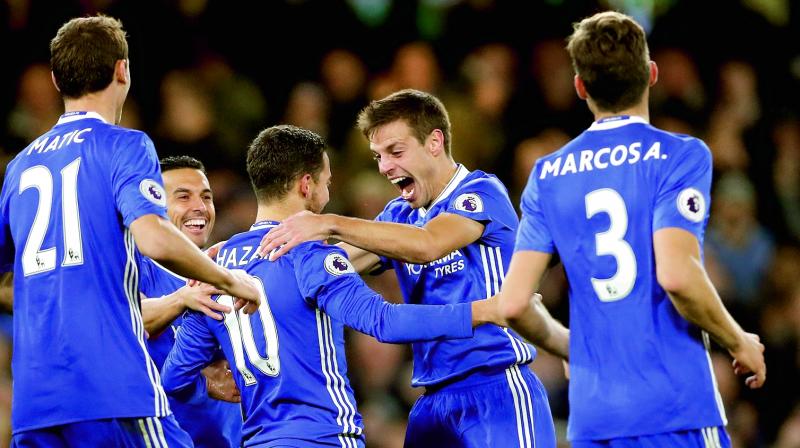 Chelseas Eden Hazard (third from left) celebrates with team mates after scoring against Everton at Stamford Bridge in London on Saturday. The host won 5-0. (Photo: AP)