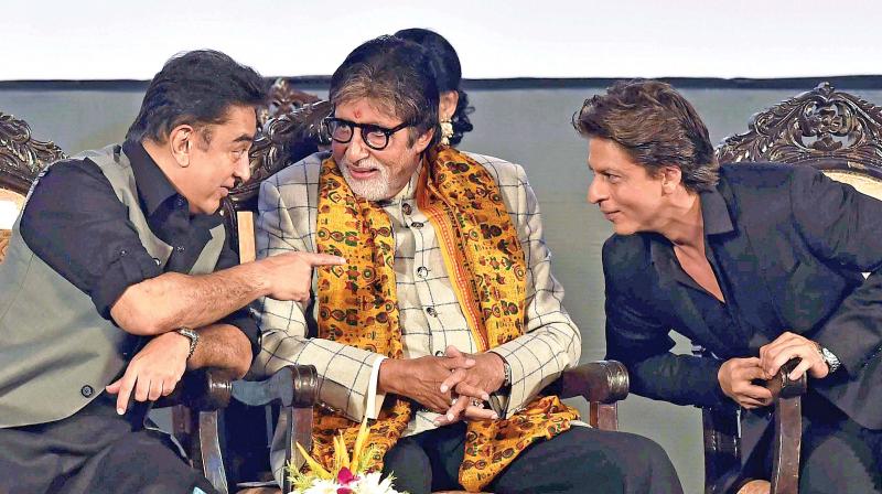 Film actors Amitabh Bachchan, Shah Rukh Khan and Kamal Hasan interact with each other during the inauguration of 23rd Kolkata International Film Festival, in Kolkata on Friday. (Photo: PTI)