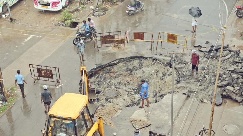 Chennai corporation workers relay damaged portion of a road in Padi on Friday. (Photo: DC)