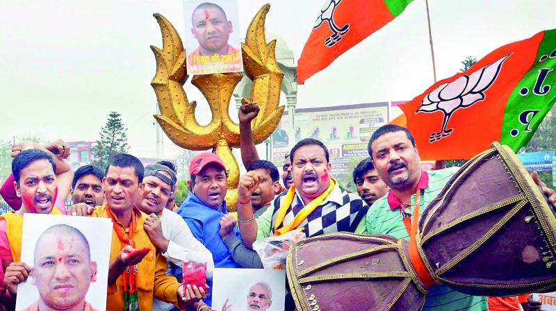 BJP workers celebrate the swearing-in of Yogi Adityanath as UP Chief Minister, in Patna on Sunday.  (Photo: PTI)