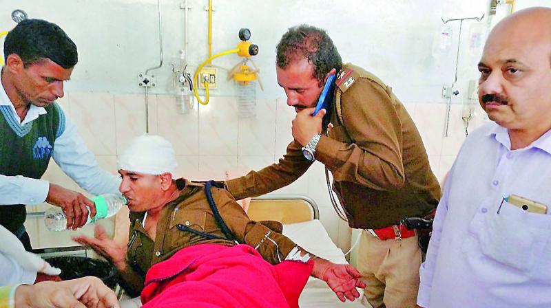 An injured police officer being treated at a hospital after a clash with Jat agitators in Hisar. (Photo: PTI)