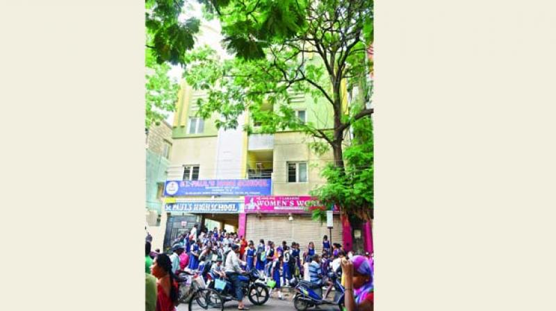 Students of St Pauls High School wait for parents to pick them up at after school hours. The school is one of the many others which are located in building complexes and apartments