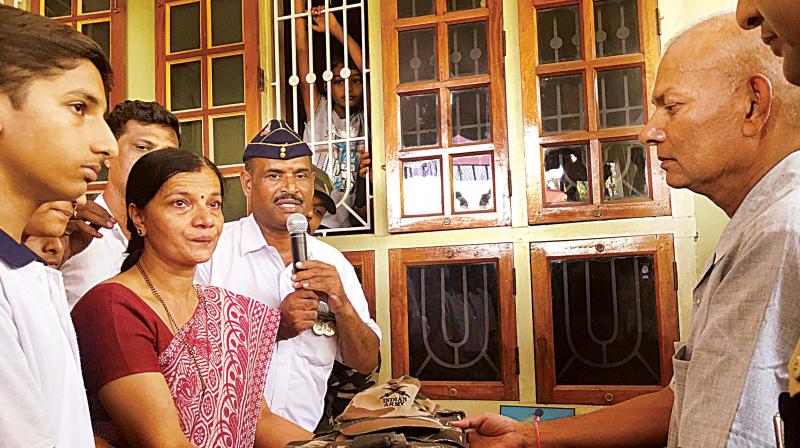 Family members of Subedar Ekanath Shetty receive his belongings in Mangaluru.