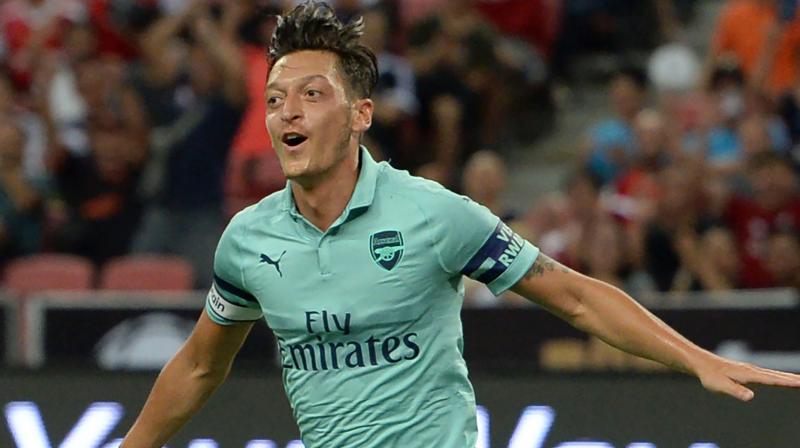 Ozil put Arsenal ahead in the 13th minute before Alexandre Lacazettes quickfire double and late strikes from Rob Holding and Eddie Nketiah against a youthful PSG side. (Photo: AFP)