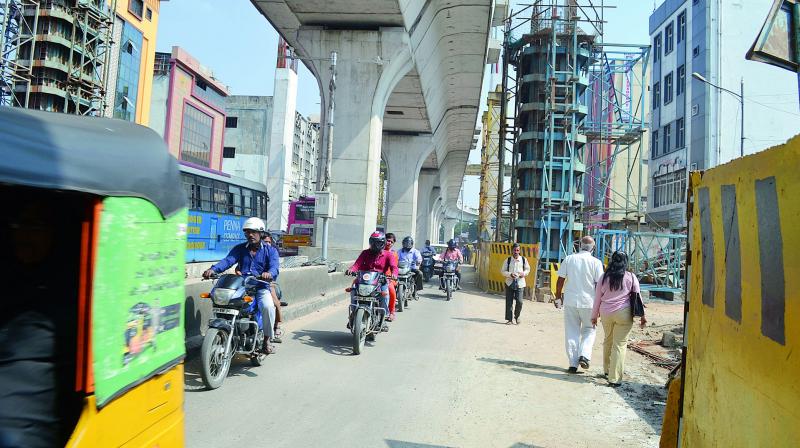 Additional pillars of Metro Rail narrowing down road space and creating additional lanes on Rang Mahal road at Putlibowli, Hyderabad.