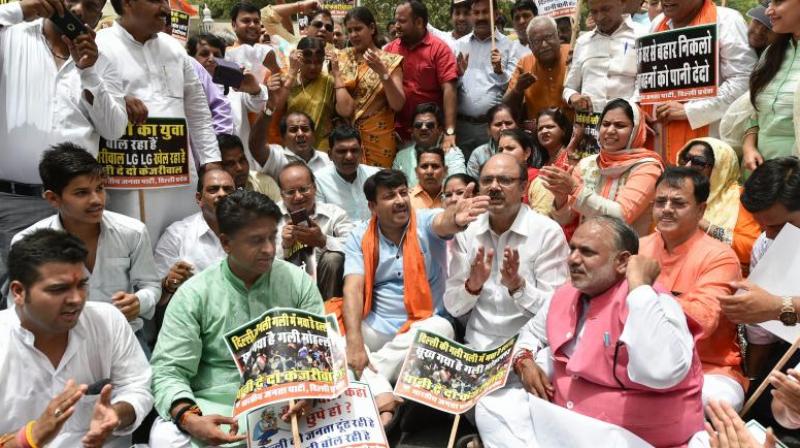Delhi BJP president Manoj Tiwari with party workers raise slogans demanding water-power supply as they march towards Delhi Chief Minister Arvind Kejriwals office. (Photo: PTI)