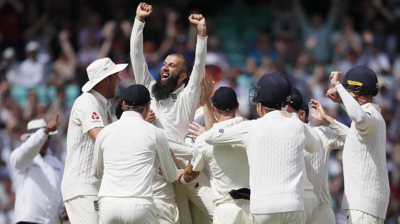 Englands Moeen Ali is lifted by his team mates after he picks up hat trick against South Africa and win the test match. (Photo: AP)