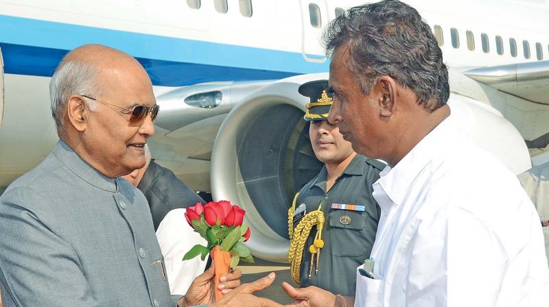 Minister for municipal administration and rural development S.P Velumani receives President Ram Nath Kovind by presenting a bouquet in Coimbatore on Sunday. (Photo: DC)