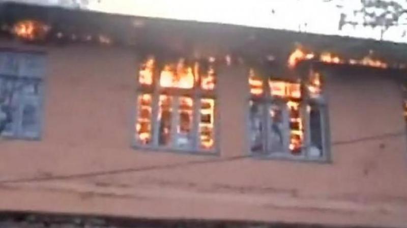 15 school buildings were saved by employees of education department and local community from being burnt. (Photo: PTI)