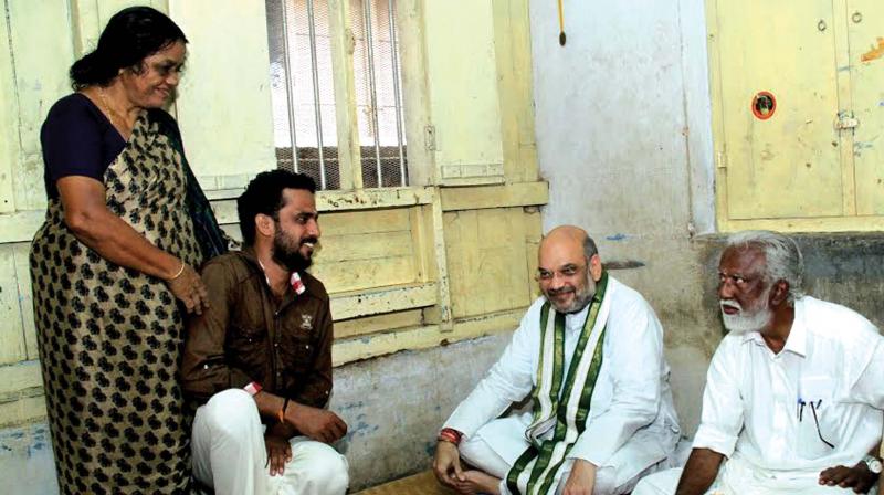 BJP national president Amit Shah has break fast at the home of S. Ratheesh Kumar, president, 95th booth, Thycaud on Sunday. State president Kummanam Rajasekharan seen nearby. (Photo: Peethambaran Payyeri)