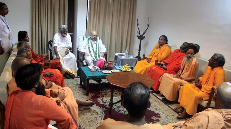 BJP national president Amit Shah holds talks with sanyasis from various religious mutts in Thiruvananthapuram on Sunday. BJP state president Kummanam Rajasekharan is also seen.	(Photo: DC)