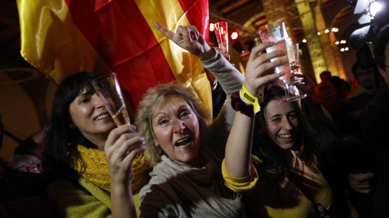 Catalan independence supporters toast as they celebrate at the ANC ( Catalan National Assembly ) headquarters after results of the regional elections in Barcelona, Spain. (Photo: AP)