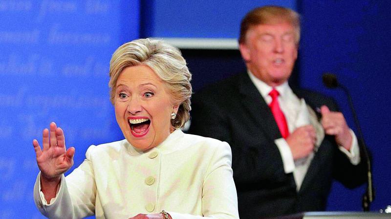 Democratic presidential nominee Hillary Clinton waves to the audience as Republican presidential nominee Donald Trump puts his notes away after the third presidential debate at UNLV in Las Vegas, on Thursday. (Photo: PTI)