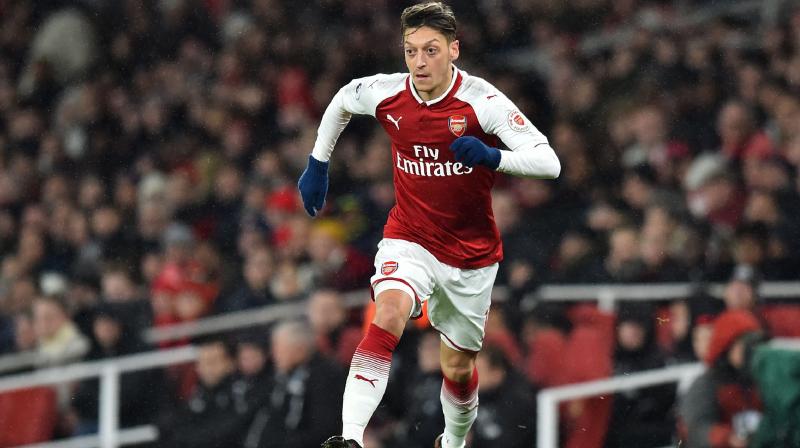 Arsenals new head coach, Unai Emery, and players have rallied round Ozil on their pre-season tour, while the hashtags #StandWithOzil and #SayNoToRacism have been popular on social media. (Photo: AFP)